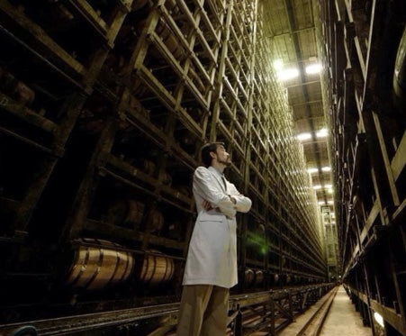 Jota Tanaka among whisky casks in the Fuji Gotemba barrel warehouse