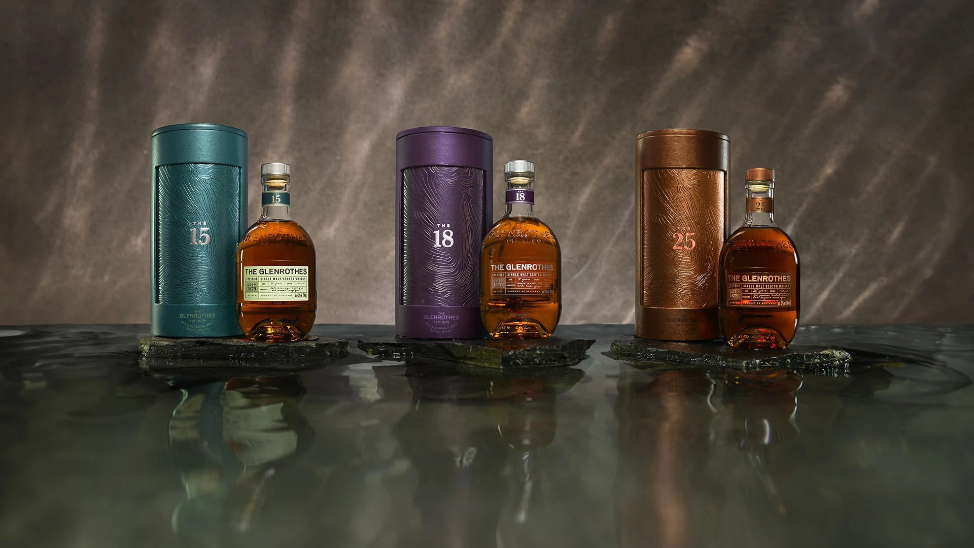 The Glenrothes 15, 18 and 25 year old whisky bottles with their canisters